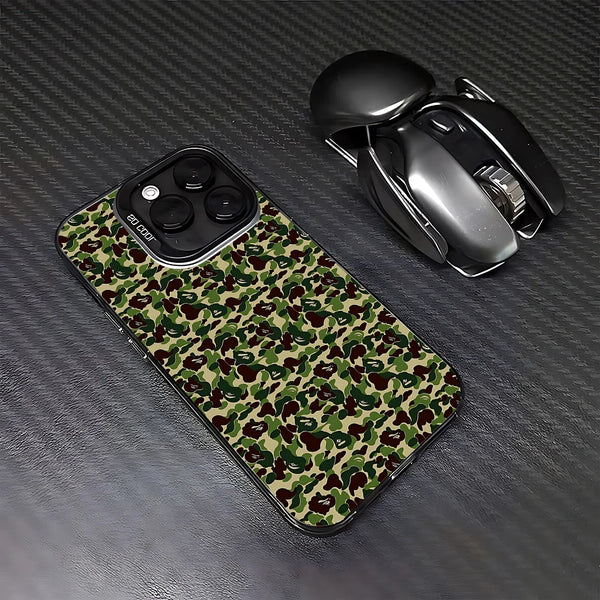 A camouflage patterned phone case for an iPhone next to a black wireless mouse.