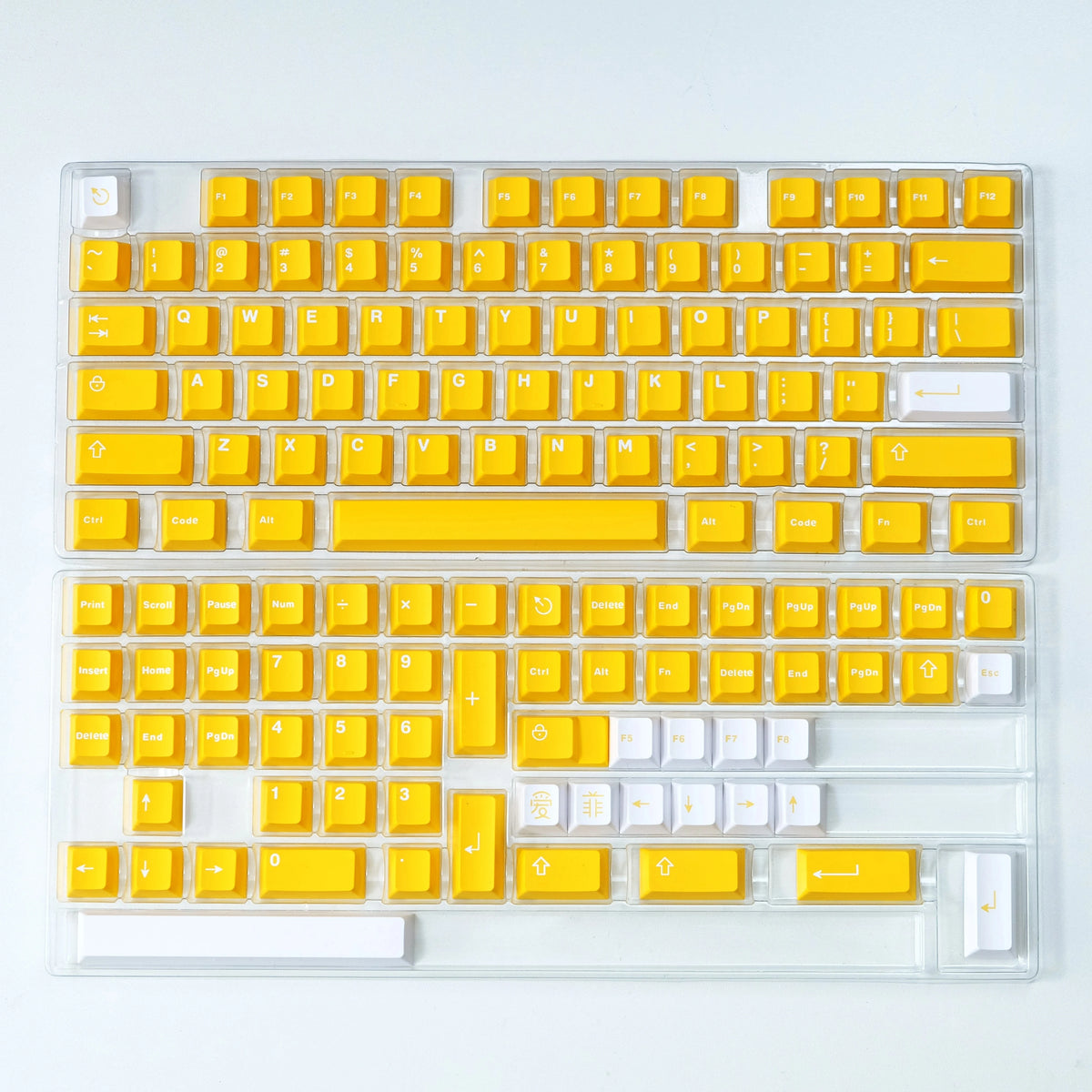 A transparent plastic keyboard featuring yellow keycaps and a white backlight.