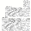 Abstract line design desk mat featuring swirling topographic lines in black and white.
