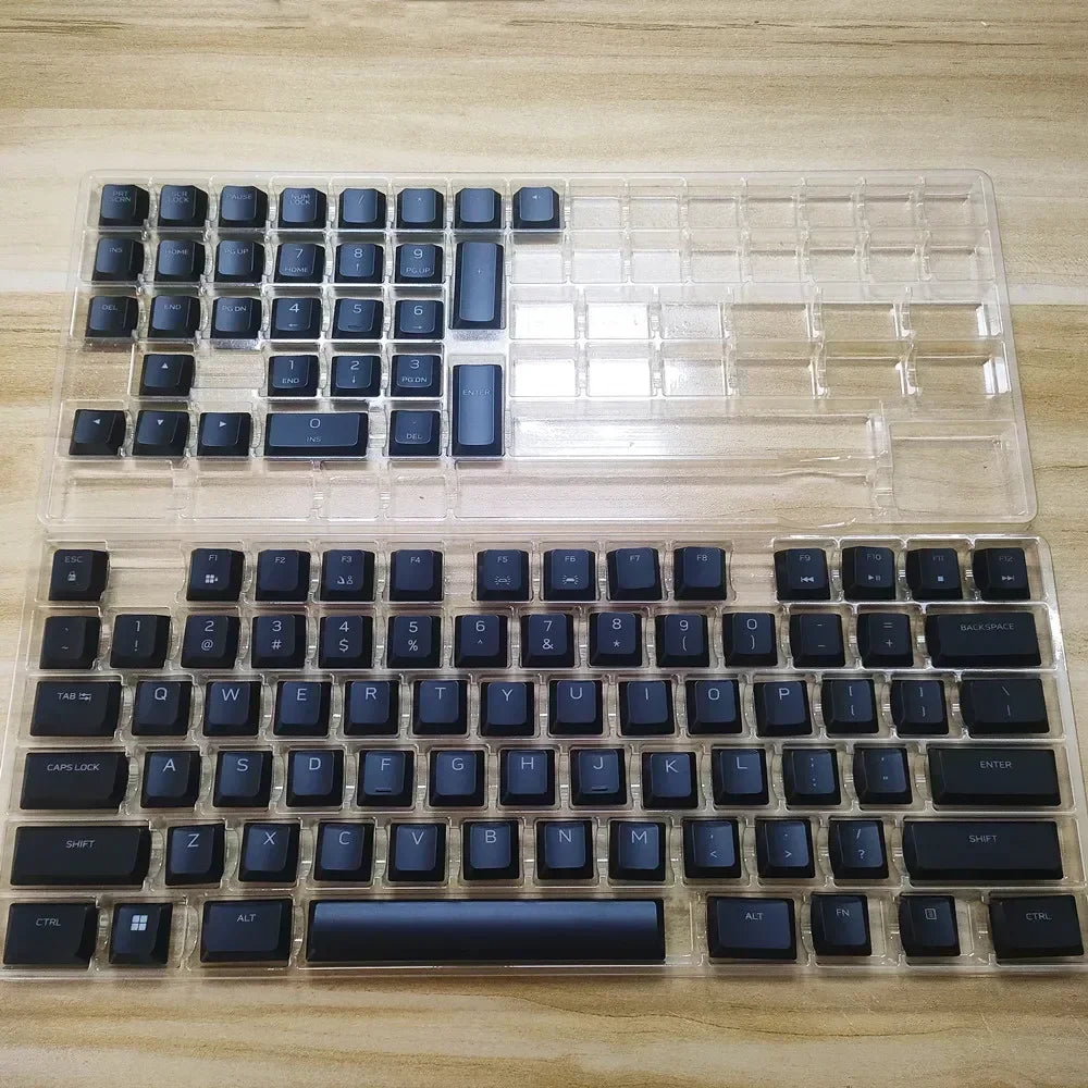A clear plastic case containing replacement keycaps for a Dell Alienware AW510K keyboard.