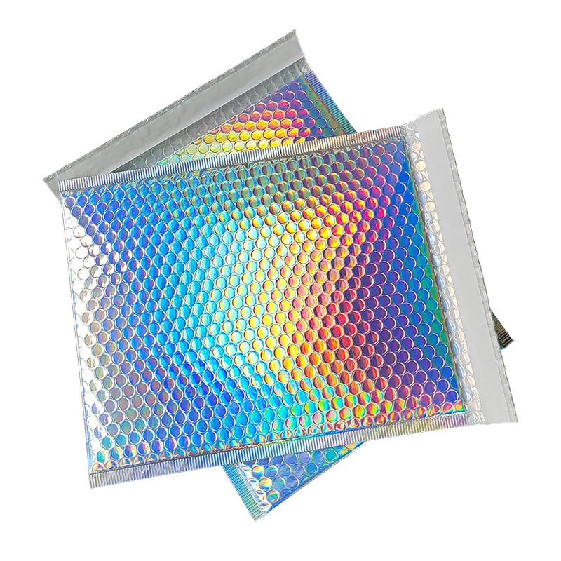 Rainbow foil bubble mailers featuring a vibrant, iridescent, multi-colored pattern.