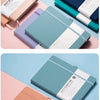 A collection of premium PU leather notebook and journal notebooks in shades of pink, blue, and dark gray on a light backgroun