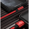 A red and black braided Lightning cable for iPhone is shown resting on a dark surface.