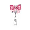 A pink strawberry-themed retractable badge reel with a bow and silver clip.