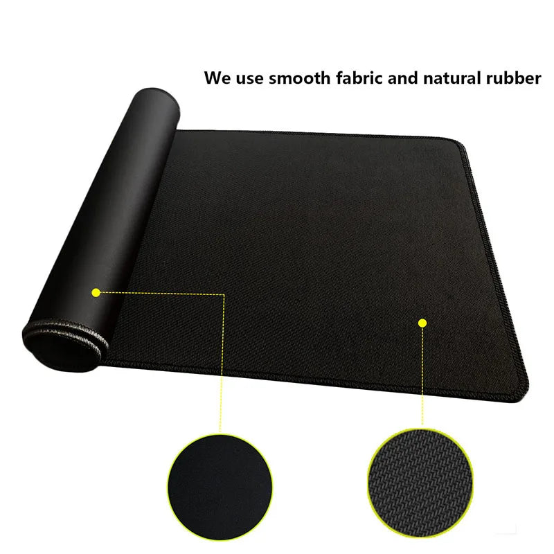 Black gaming mouse pad rolled up, showing smooth fabric and natural rubber texture.