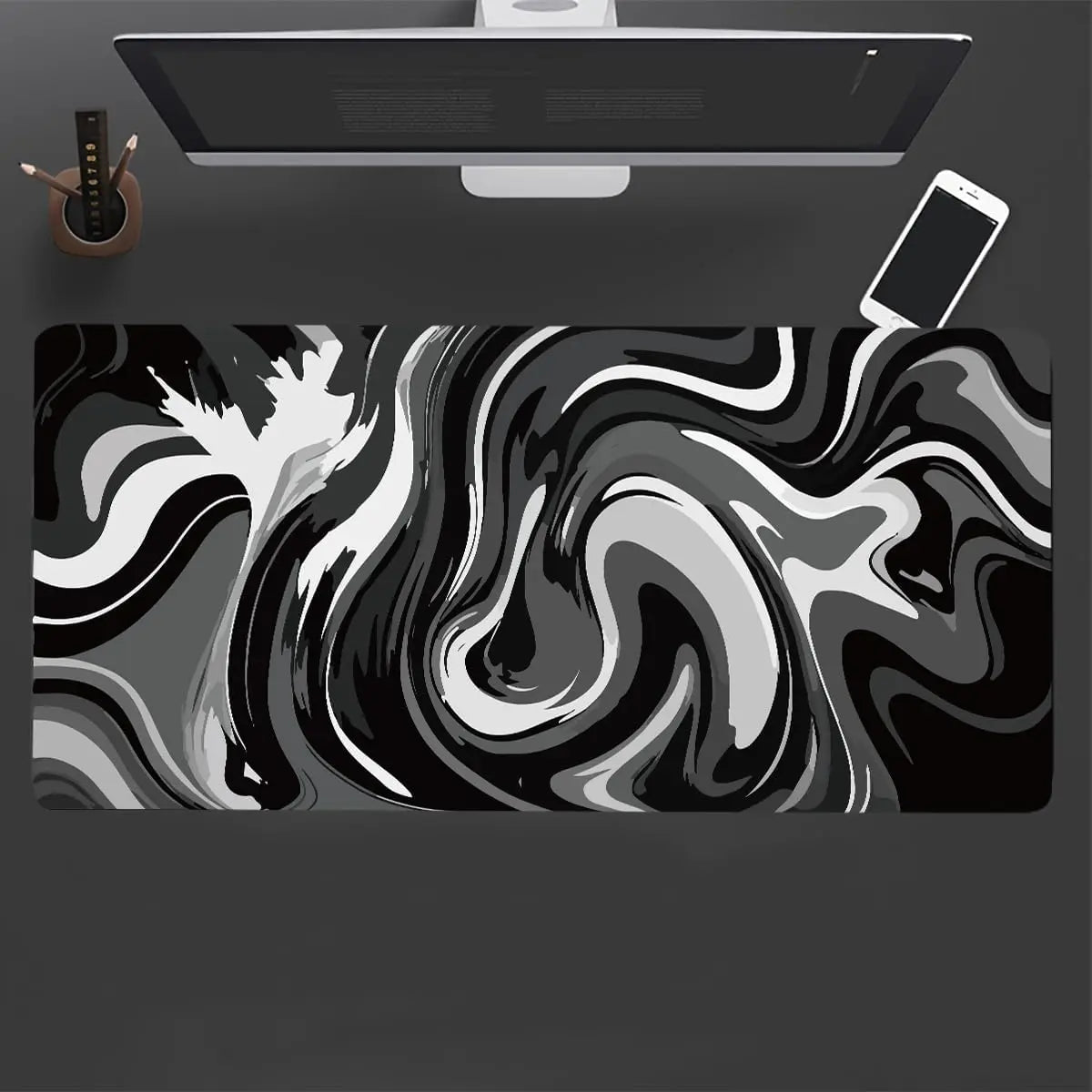 A large gaming mouse pad featuring a black and white liquid wave design, positioned under a computer monitor.