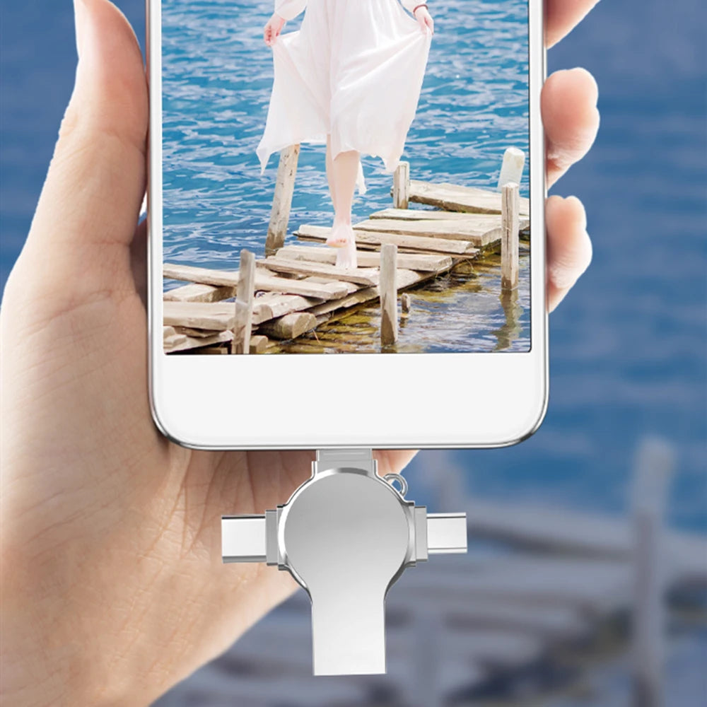 A hand holds a smartphone displaying a picture of a person walking on a wooden pier over blue water.