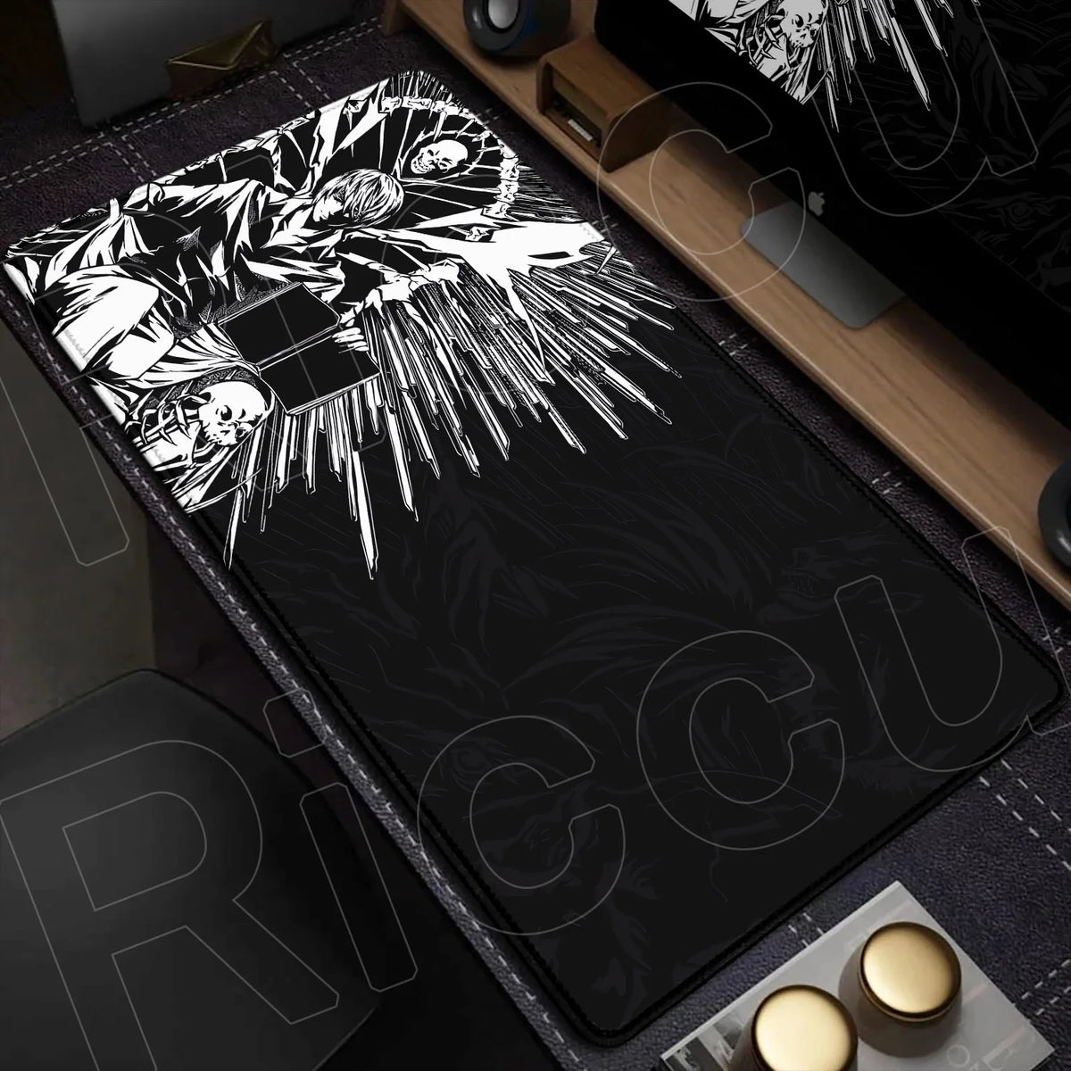 A black mouse pad featuring a white illustration of Death Note characters and stylized foliage on a wooden desk.