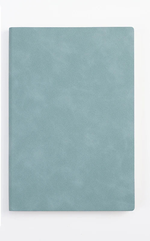 A smooth, light blue leather journal or diary lying flat against a white background.
