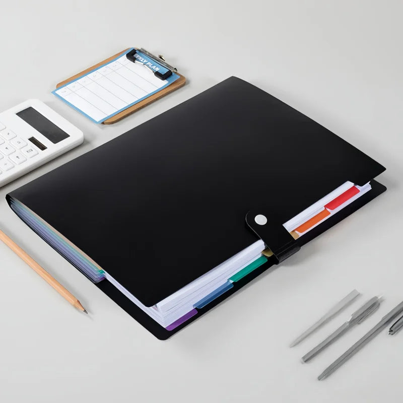 A black A4 7-pocket expanding file folder for documents and organization next to a calculator and pencils.