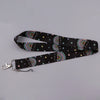 Black fabric lanyard with a rainbow pattern and small hearts for badges and keys
