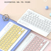 A white keyboard and mouse combo set featuring a pink color scheme, displayed on a light pink background.