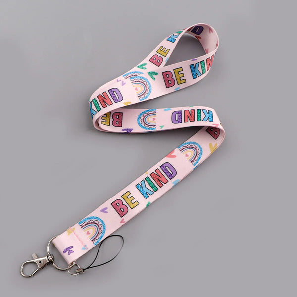 Pink lanyard with rainbow text that reads Be Kind