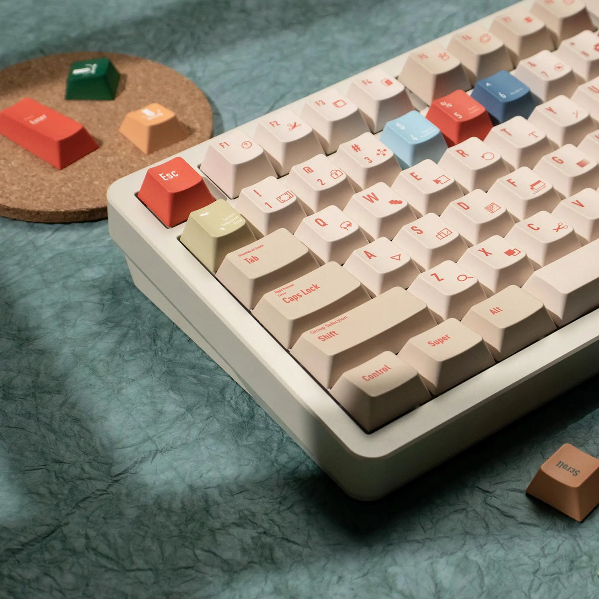 A close-up view of a white mechanical keyboard with retro colored PBT keycaps, including red, orange, and blue keys.