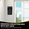 A black mounted collection box with a key lock installed on a white wall next to a glass door.