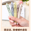 A hand holds several pastel colored Uni-Ball One Mini Cute Gel Pens, showcasing their compact design and smooth finish.