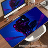 A dark blue desk mat featuring a purple Spider-Man silhouette against a bright blue background.