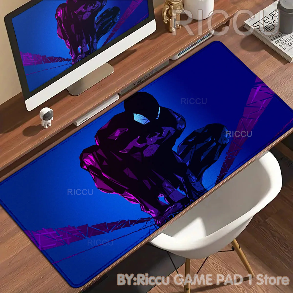 A dark blue desk mat featuring a purple Spider-Man silhouette against a bright blue background.