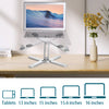 A silver adjustable stand holding a laptop displaying a scenic landscape, next to various sized tablets.