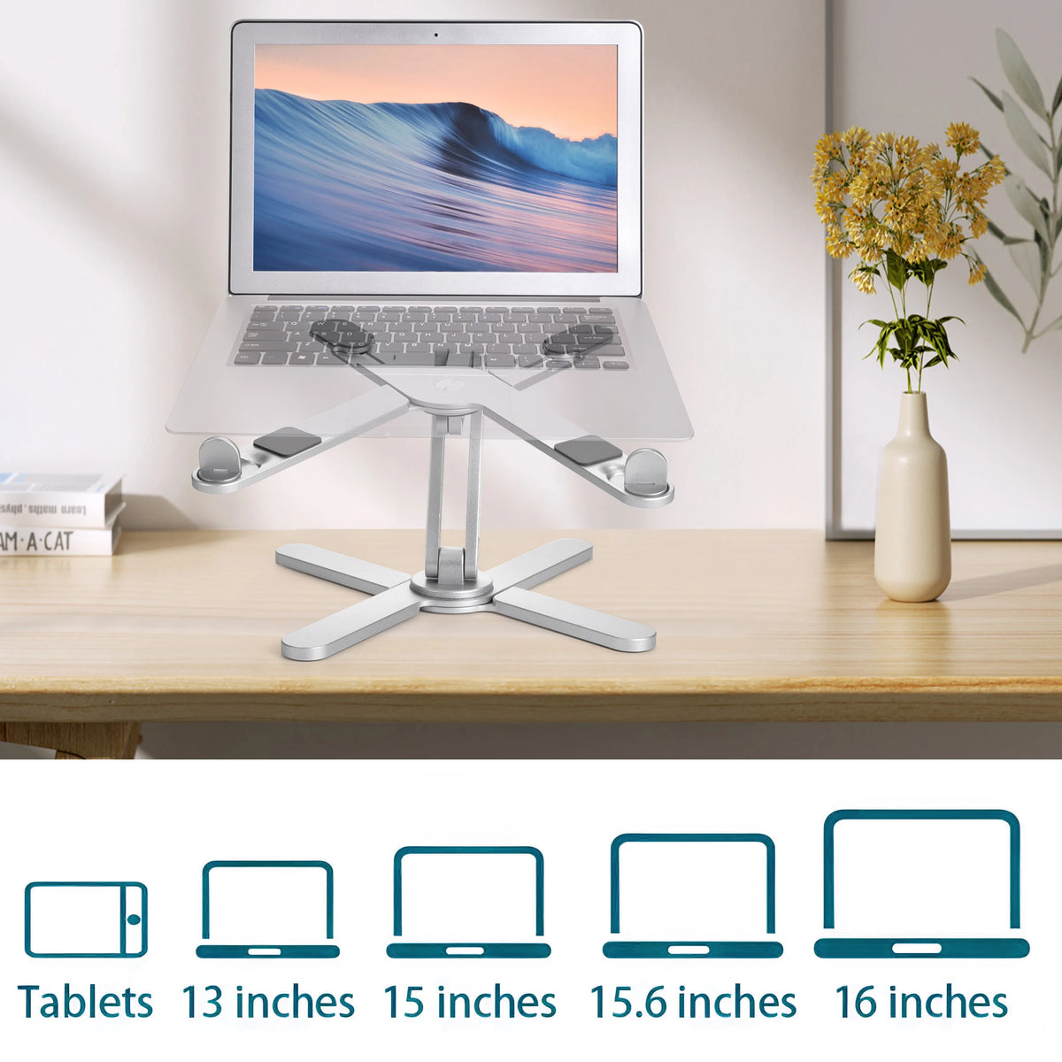 A silver adjustable stand holding a laptop displaying a scenic landscape, next to various sized tablets.