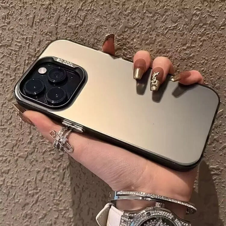 A hand holds a silver phone case with a leopard print design against a textured wall.