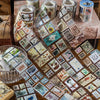A close-up of vintage stamp tape stickers arranged in various patterns on a wooden surface.