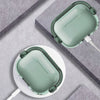 A silicone lock case for AirPods is shown in light green and white on a gray surface.