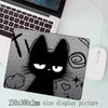 A black cat silhouette design on a mouse pad with a non-slip rubber base.