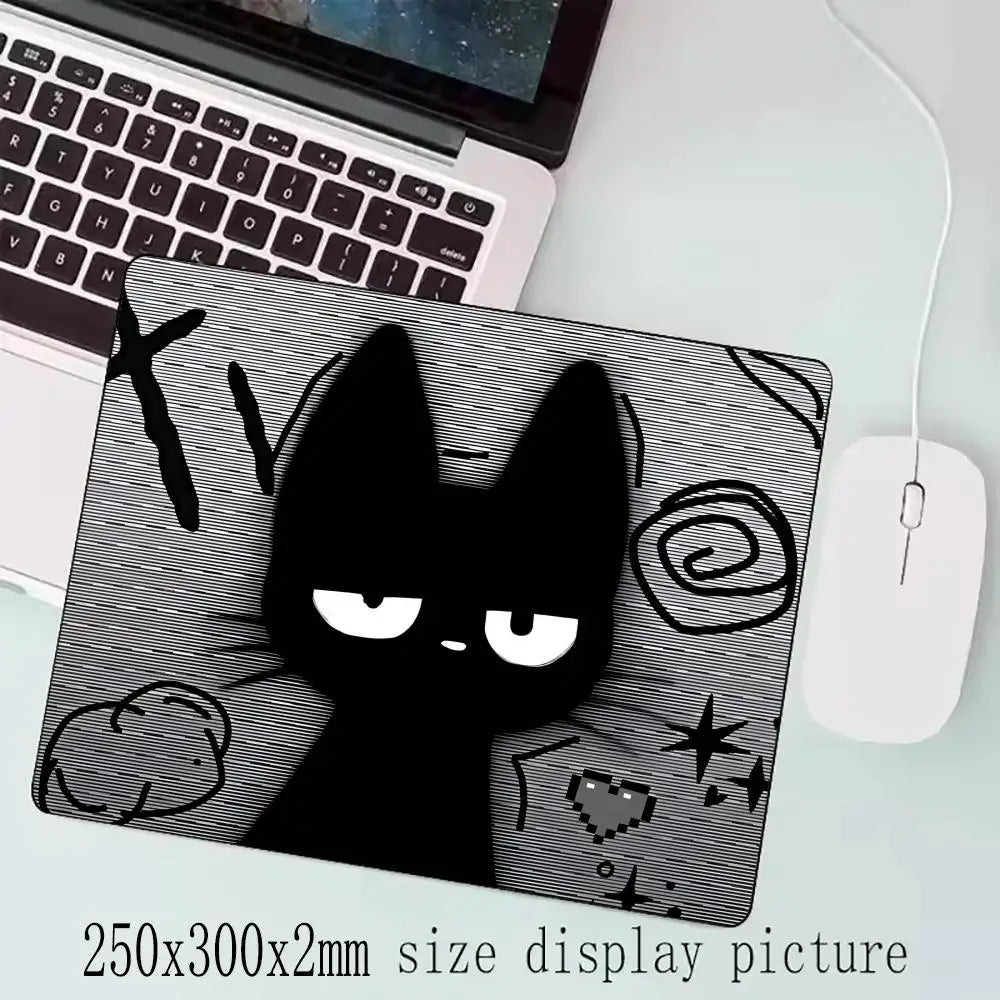 A black cat silhouette design on a mouse pad with a non-slip rubber base.