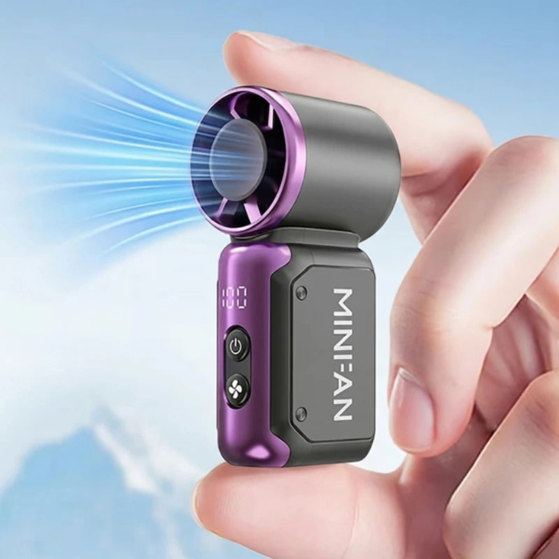 A hand holds a portable USB rechargeable mini fan with a purple lens and silver body, emitting a blue light beam.