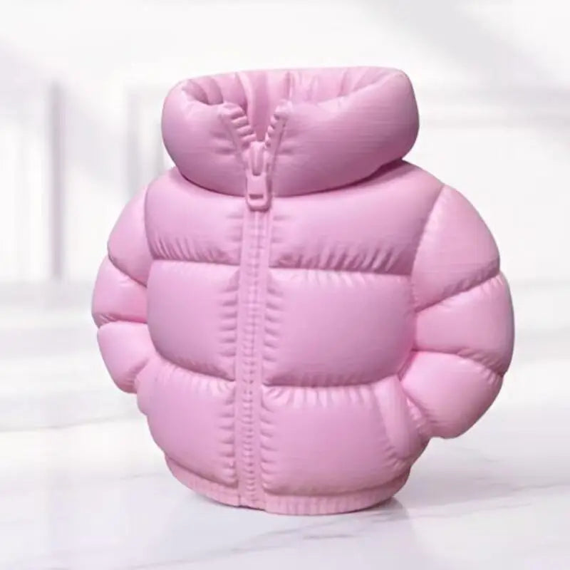 A pink puffer jacket shaped like a pen holder or desk organizer resting on a white surface.