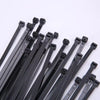 A collection of black heavy-duty nylon cable ties with self-locking designs arranged diagonally.