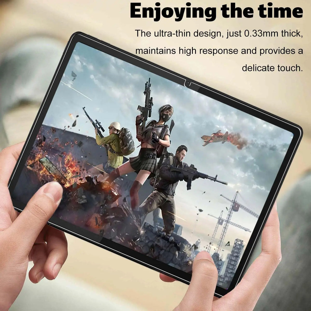 A hand holds a tablet displaying an intense military action scene, highlighting the ultra-thin design.
