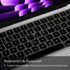 A close-up view of a silicone keyboard cover protecting a laptop keyboard, showing purple and silver accents.