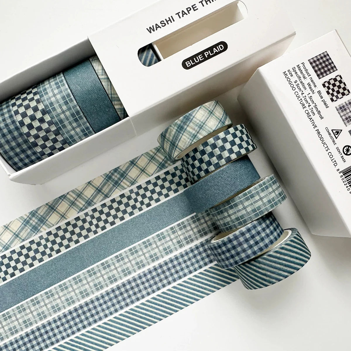 A set of blue plaid washi tape rolls featuring decorative grid and polka dot patterns, displayed in its packaging.