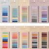 A collection of transparent self-adhesive sticky notes in various shades of pink, blue, green, and gray stacked vertically.