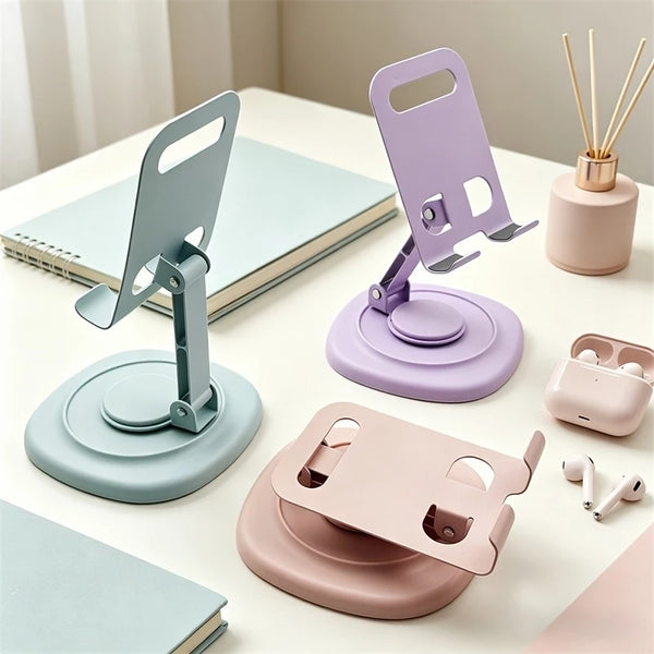 A set of purple and mint green 360° rotating foldable desktop phone stands displayed on a white surface.