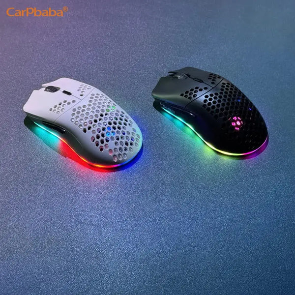 A white and black wireless gaming mouse with vibrant RGB lighting resting on a blue surface.