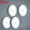 Four white motion sensor LED night lights displayed against a gray background.