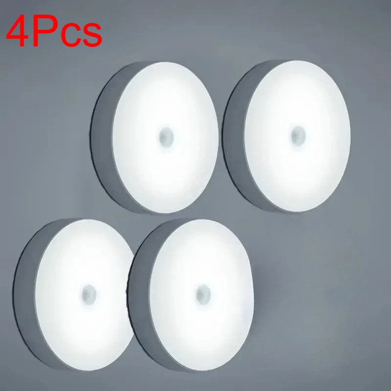 Four white motion sensor LED night lights displayed against a gray background.