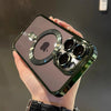 A hand holds a clear magnetic case with a green plated finish for a MagSafe iPhone.