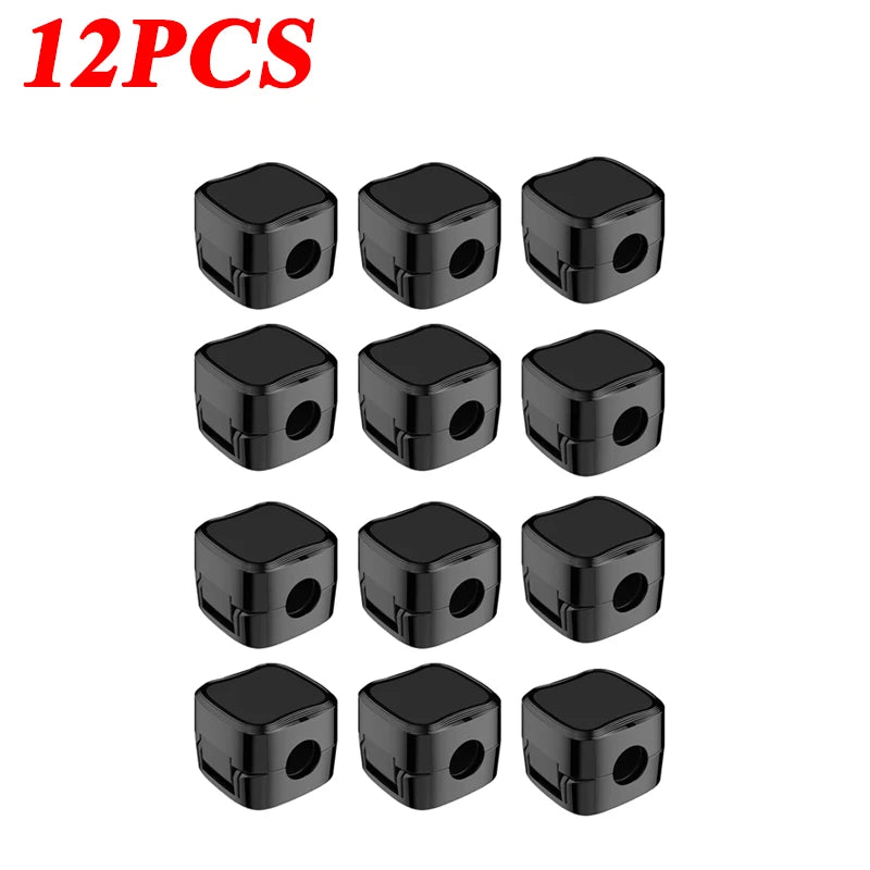 Twelve black magnetic cable clips arranged in a row for desk organization.