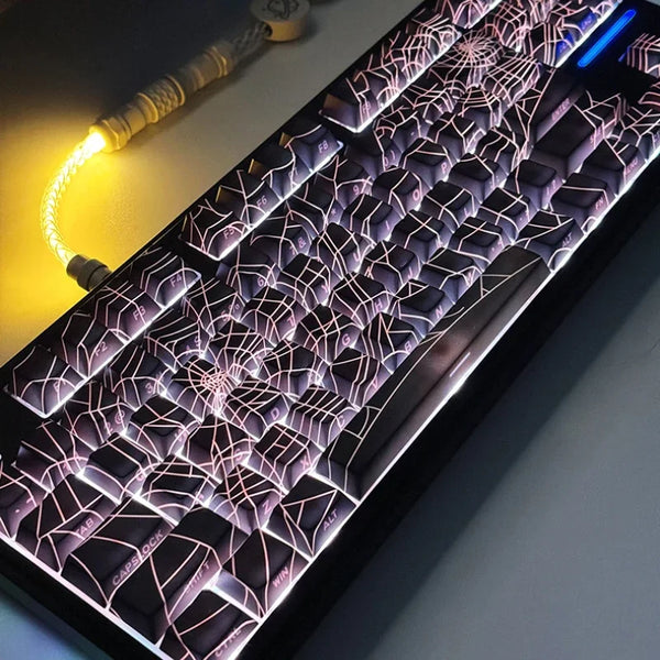 Close-up of a mechanical keyboard with translucent cherry keycaps illuminated by pink and purple LED lighting.