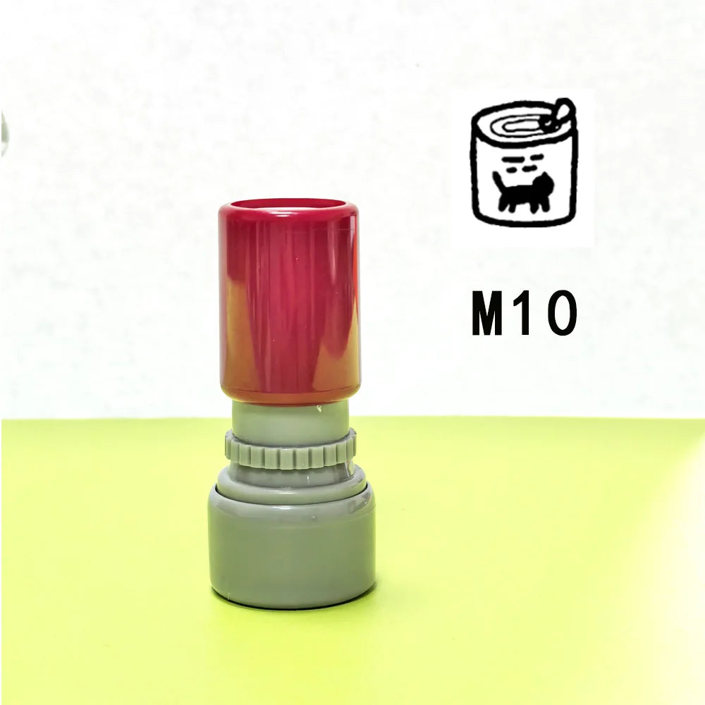 A red and gray teacher stamp with a cat pattern is shown on a light green surface.