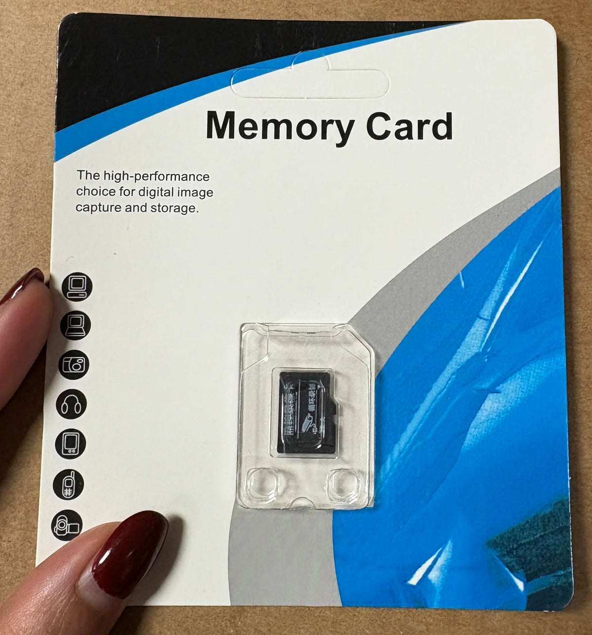 A white card packaging for a Memory Card with a clear plastic memory card visible inside.