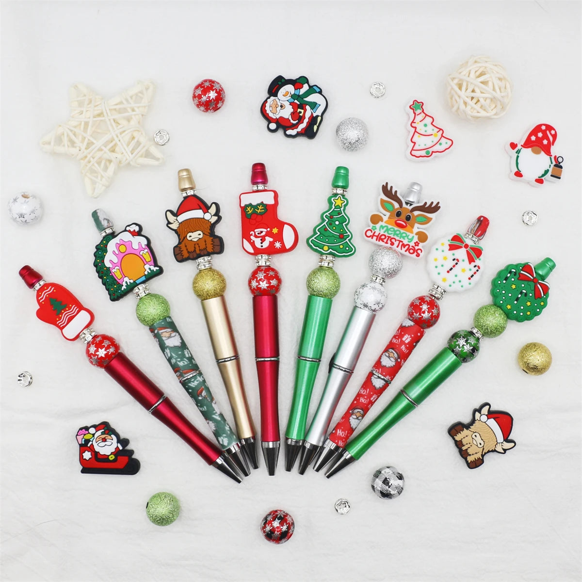 A set of decorative beaded ballpoint pens featuring Christmas and winter themes.