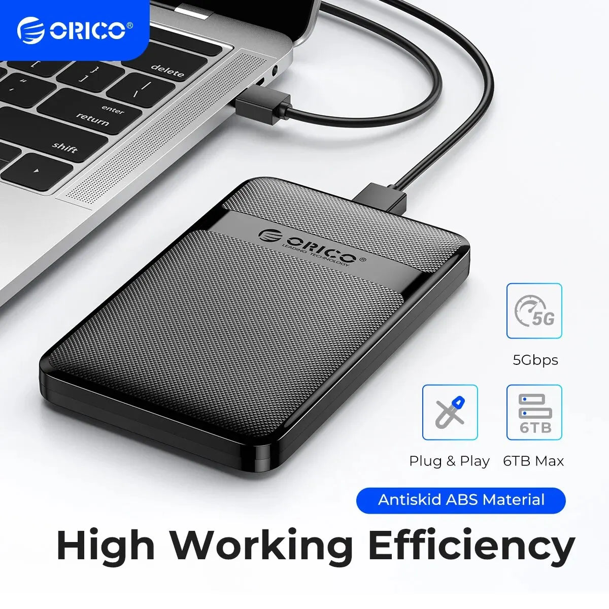 A black ORICO 5G hard drive enclosure with a cable, shown next to a laptop keyboard.