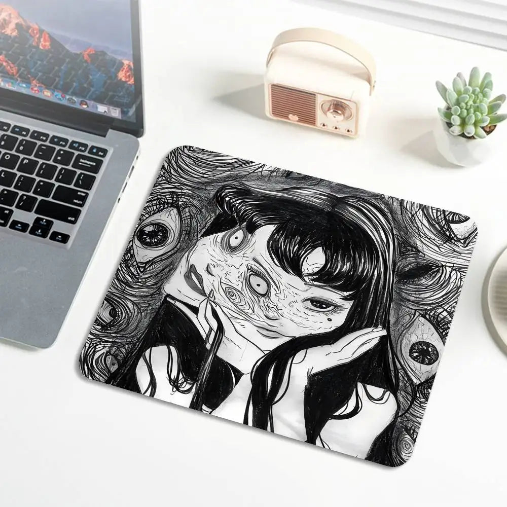 A black and white illustration of a distressed woman with swirling lines on a mouse pad.