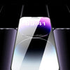 A close-up view of a smartphone screen protector being applied to an iPhone, highlighting its clear glass surface.