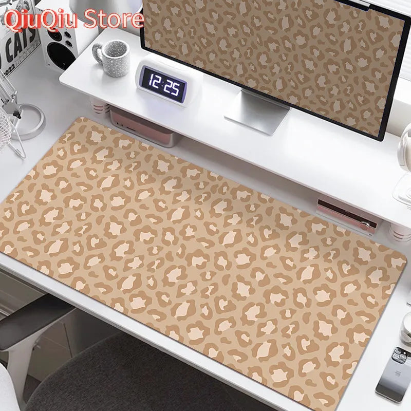 A large leopard print desk pad is displayed on a white desk next to a digital clock.